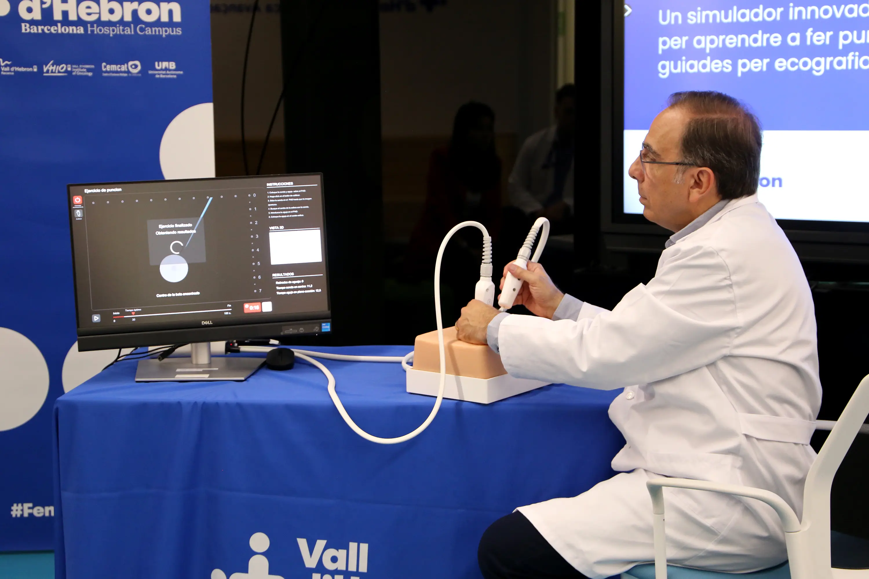 Clinician practicing an ultrasound-guided puncture on the Winco USG haptic pad with the computer-generated simulation on screen